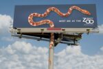 snake climibing billboard milwaukee zoon